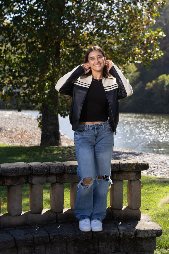 Knoxville high school, senior poses near a river for her portrait session