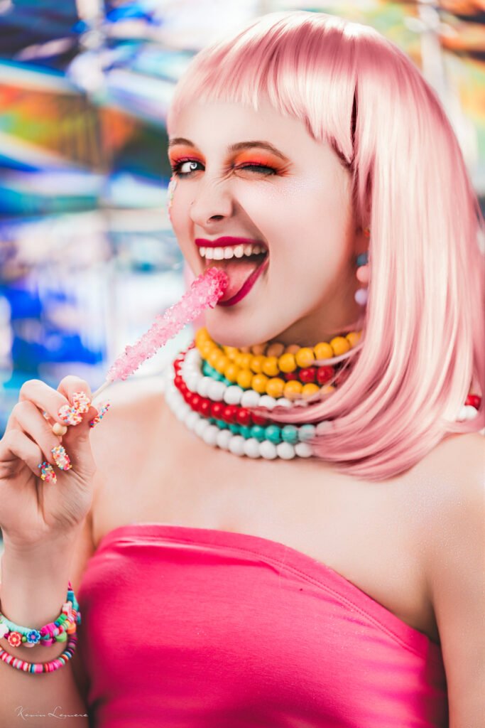 A creator team senior posing in a candy photoshoot